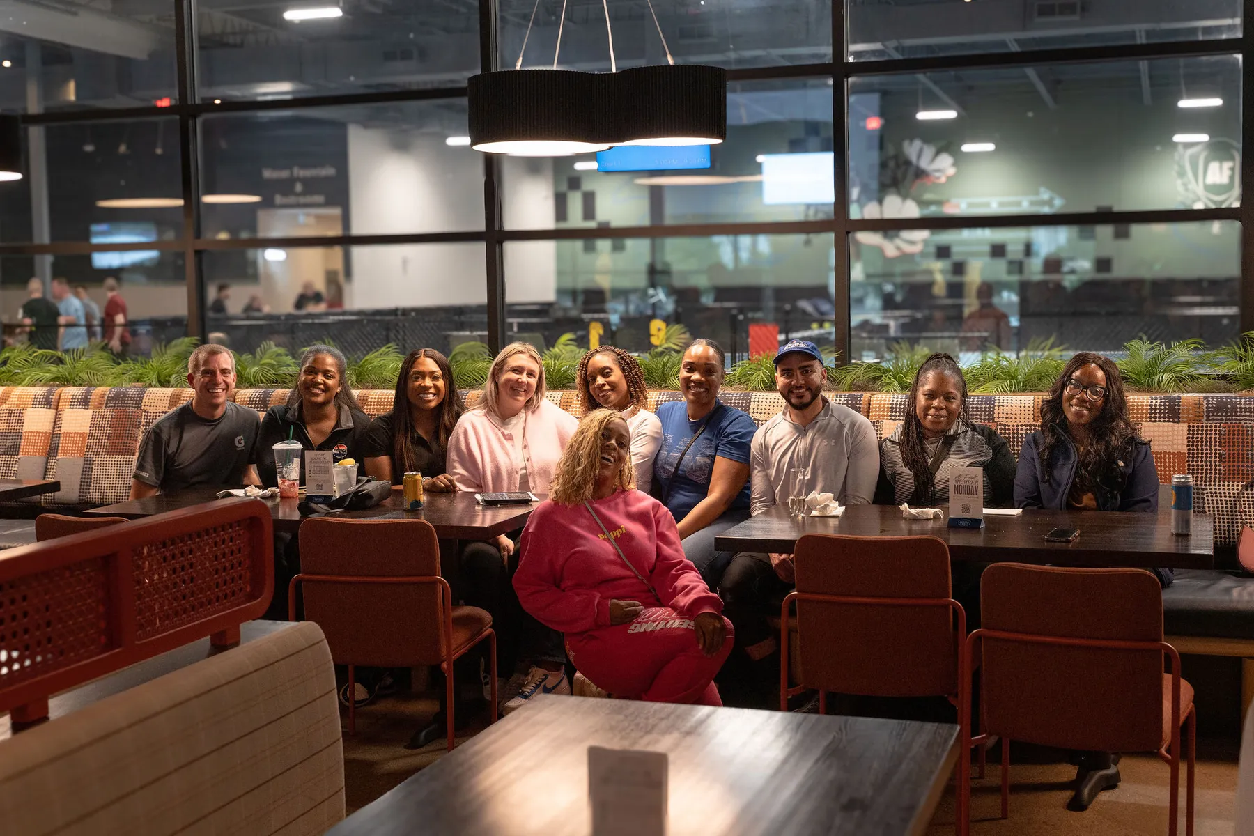 Group of friends sharing dinner and drinks at At Fault