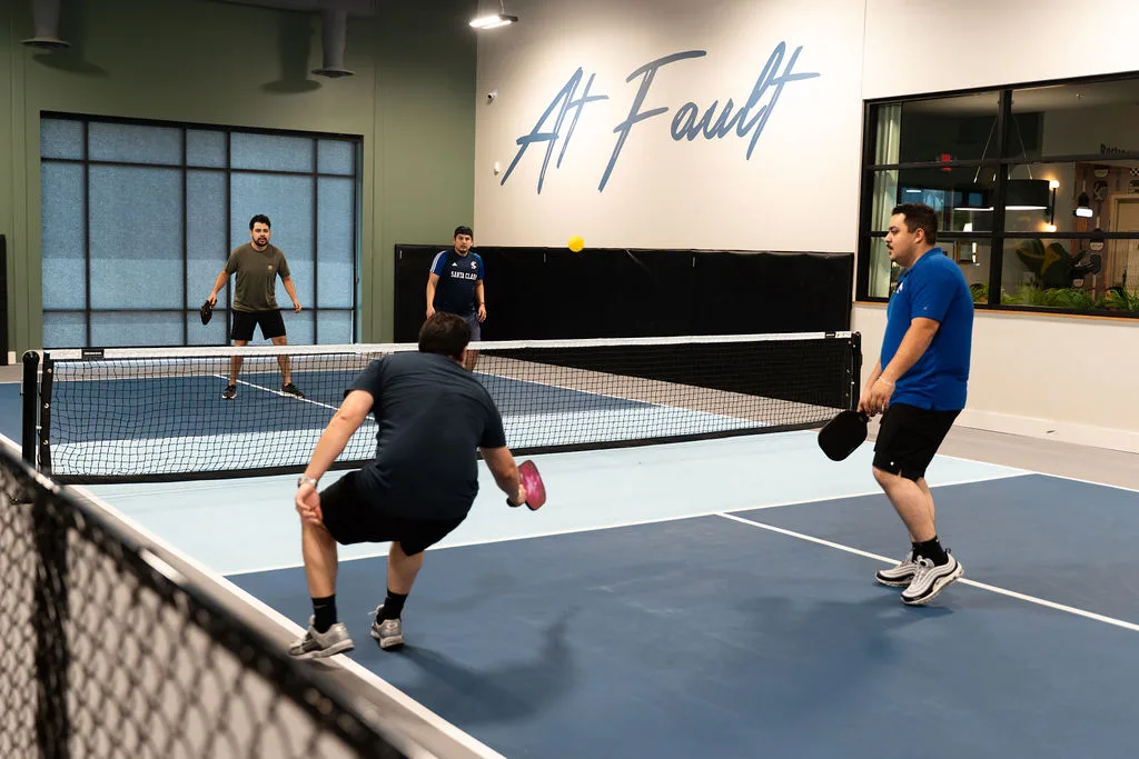 Players on the indoor pickleball courts at At Fault