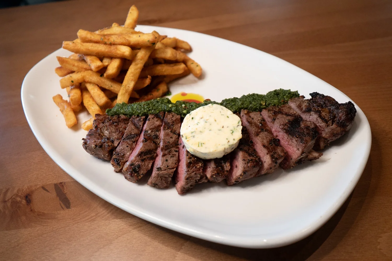 Sliced grilled steak with herb butter