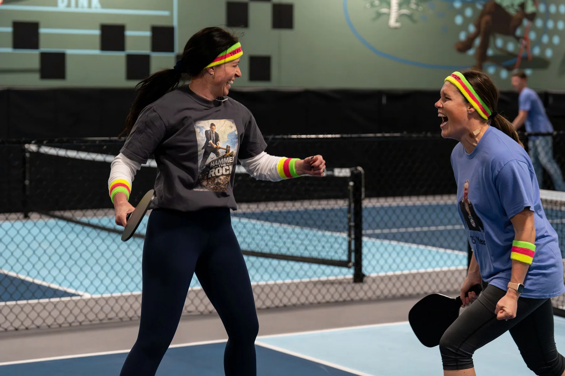 Two players congratulate each other after a pickleball point